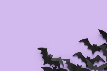 Paper bats for Halloween party on lilac background