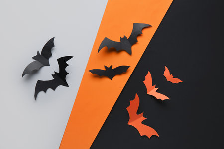 Paper bats for Halloween party on colorful backgroundの写真素材