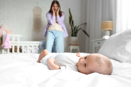 Baby and young mother suffering from postnatal depression at homeの写真素材