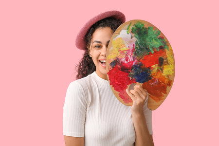 Female African-American artist on pink backgroundの写真素材