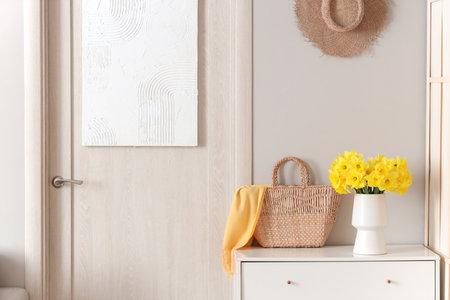 Stylish interior of hall with chest of drawers and doorの写真素材