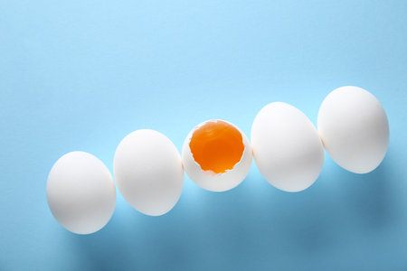 Raw chicken eggs on blue backgroundの写真素材