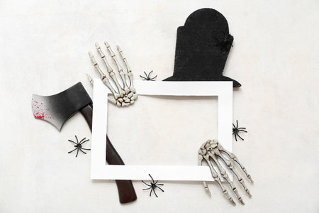Composition with blank picture frame and decorations for Halloween on light backgroundの写真素材