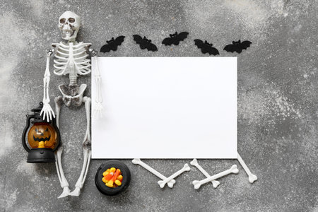 Composition with blank card, decorations and candies for Halloween on grunge backgroundの写真素材