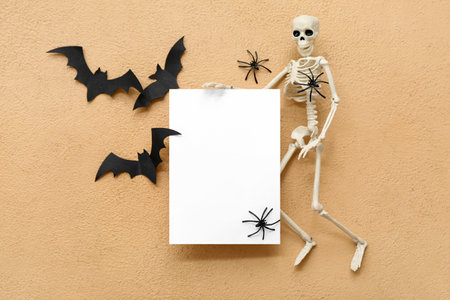 Composition with blank card, skeleton, bats and spiders on color backgroundの写真素材