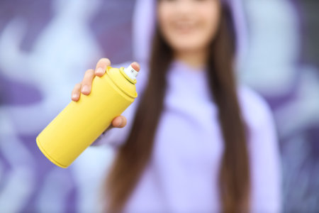 Teenage girl with spray paint outdoorsの写真素材