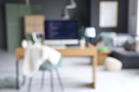 Interior of office with programmer's workplace decorated for Christmas, blurred viewの写真素材