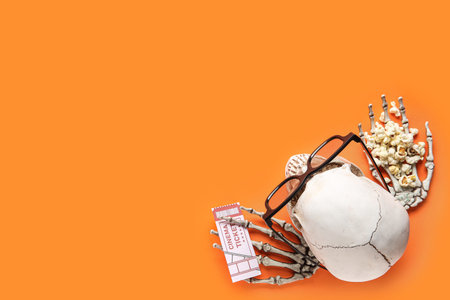 Composition with cinema ticket, popcorn, 3D glasses and human skull for Halloween on color...