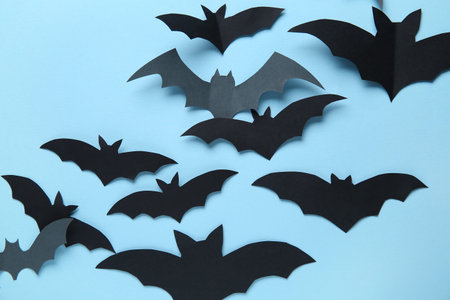 Paper bats for Halloween party on blue background
