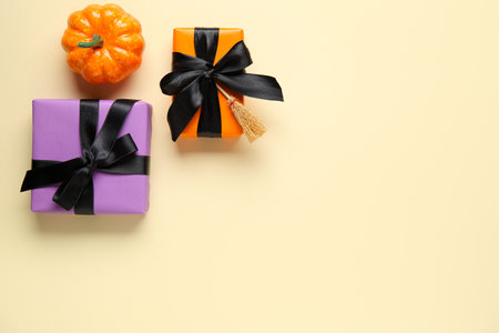 Halloween gifts and pumpkin on beige background. Top viewの写真素材