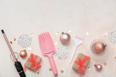 Hairdresser's tools with Christmas decor and presents on light backgroundの写真素材