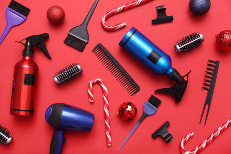 Hairdresser's tools with Christmas balls and candy canes on red backgroundの写真素材