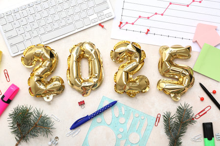 Figure 2025 with Christmas branches and office stationery on light background