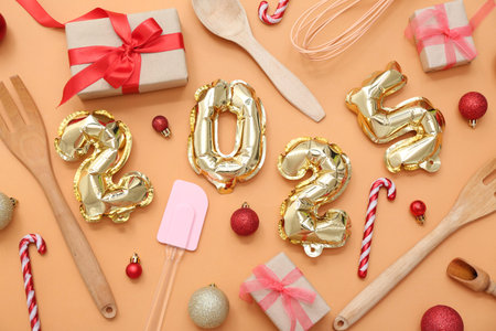 Figure 2025 with cooking utensils and Christmas balls on orange background
