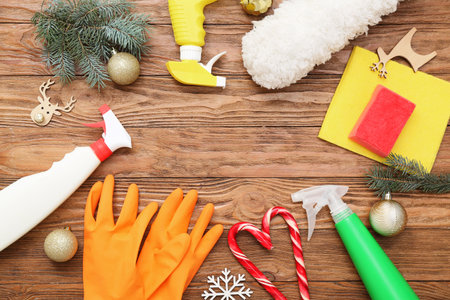 Frame made of cleaning supplies with Christmas decor on wooden backgroundの写真素材