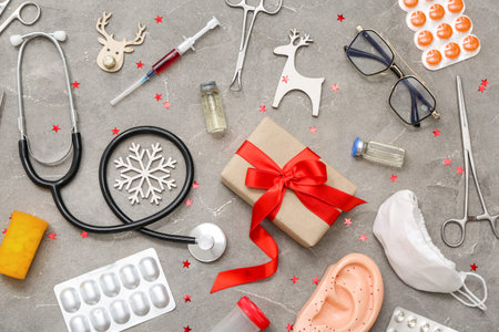 Medical supplies with gift and Christmas decor on grunge background