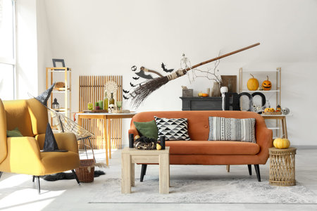 Light living room with orange sofa decorated for Halloween celebrationの写真素材