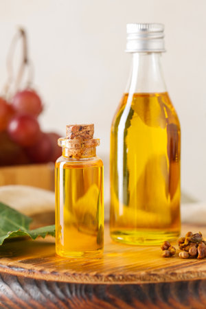 Bottles of cosmetic grape seed oil on white backgroundの写真素材