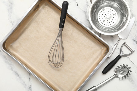 Composition with baking tray and kitchen utensils on light backgroundの写真素材