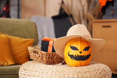 Pumpkin and basket with Halloween gift on coffee table in roomの写真素材
