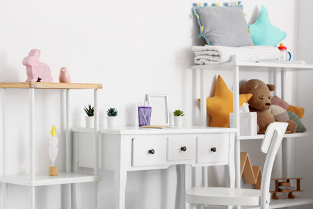 Interior of children's room with table, shelf units and toysの写真素材