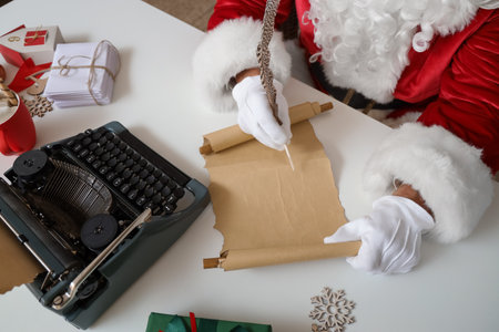 Santa Claus writing letter at home on Christmas Eve, closeupの写真素材