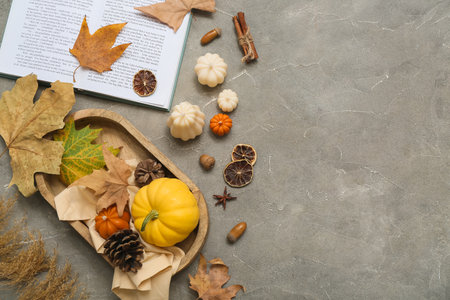 Autumn composition with candles, book and autumn leaves on grunge backgroundの写真素材