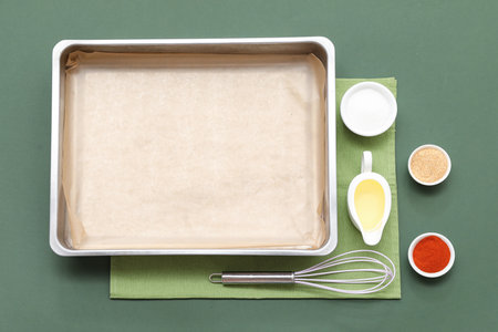 Composition with empty baking tray, whiskey and spices on color backgroundの写真素材