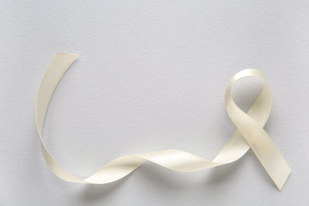 White ribbon on gray background. World Cancer Day
