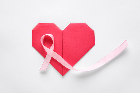 Pink ribbon and heart on white background. World Cancer Dayの写真素材