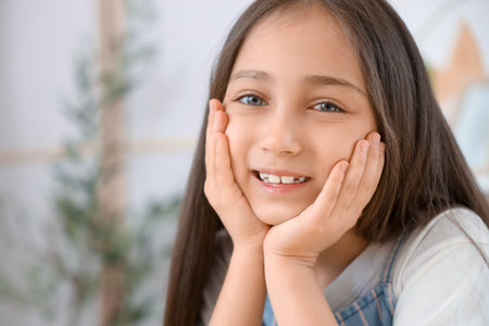 Cute little girl smiling at home, closeup