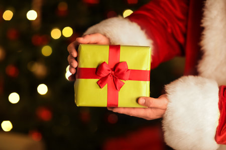 Santa Claus hands with gift box on Christmas eve at home, closeupの写真素材