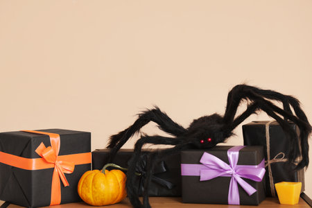 Spider on gift boxes for Halloween near beige wall. Closeupの写真素材