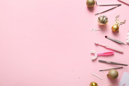 Composition with different dentist's tools and Christmas decorations on pink backgroundの写真素材