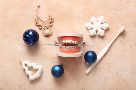 Composition with jaw model, toothbrush and Christmas decorations on color backgroundの写真素材