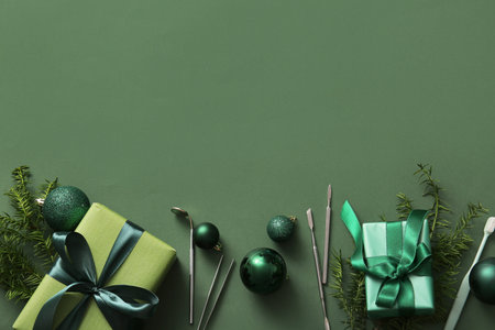 Composition with dentist's tools, Christmas gifts and decorations on green backgroundの写真素材