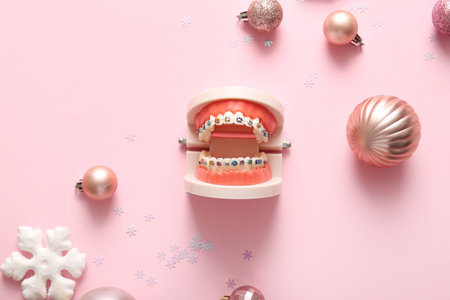 Composition with jaw model and Christmas decorations on pink backgroundの写真素材
