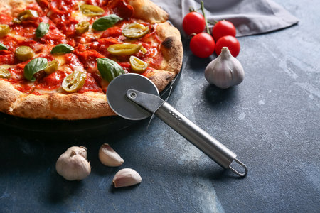 Composition with tasty pizza, ingredients and cutter on blue background, closeupの写真素材