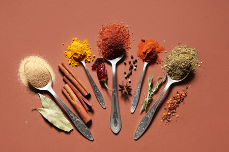 Composition with spoons of fresh aromatic spices on color backgroundの写真素材