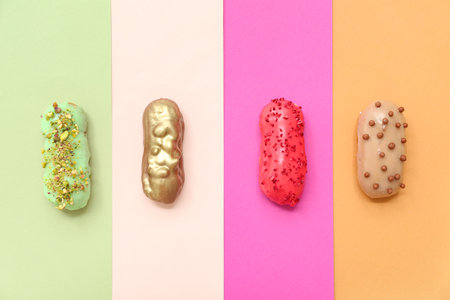 Composition with delicious glazed eclairs on color backgroundの写真素材