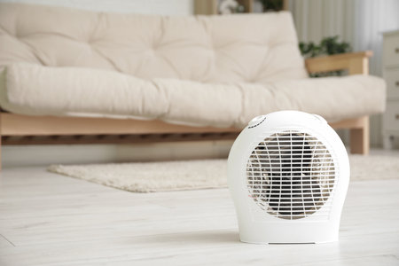 Electric fan heater on floor in living room, closeupの写真素材