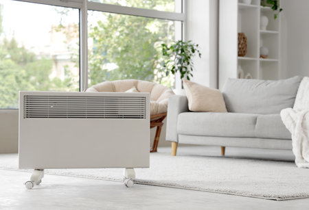 Electric heater on floor in living roomの写真素材
