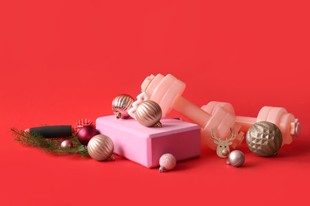 Composition with sports equipment and beautiful Christmas decorations on red backgroundの写真素材