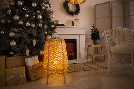 Interior of living room with fireplace, Christmas trees and glowing lampの写真素材