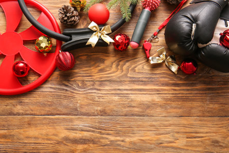Composition with sports equipment and Christmas decorations on wooden backgroundの写真素材