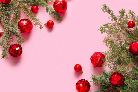Fir branches with Christmas balls on pink backgroundの写真素材