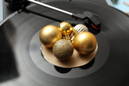 Vinyl record player with disc and Christmas balls, closeup