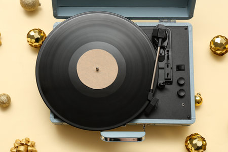 Vinyl record player with disc and Christmas balls on yellow backgroundの写真素材
