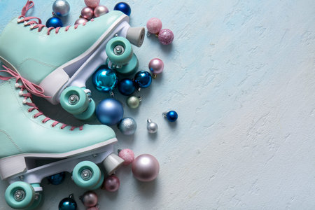 Composition with roller skates and different Christmas balls on light background