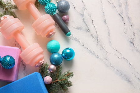Composition with sports equipment, fir branches and Christmas balls on light backgroundの写真素材